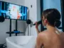 Woman singing karaoke in a bathtub
