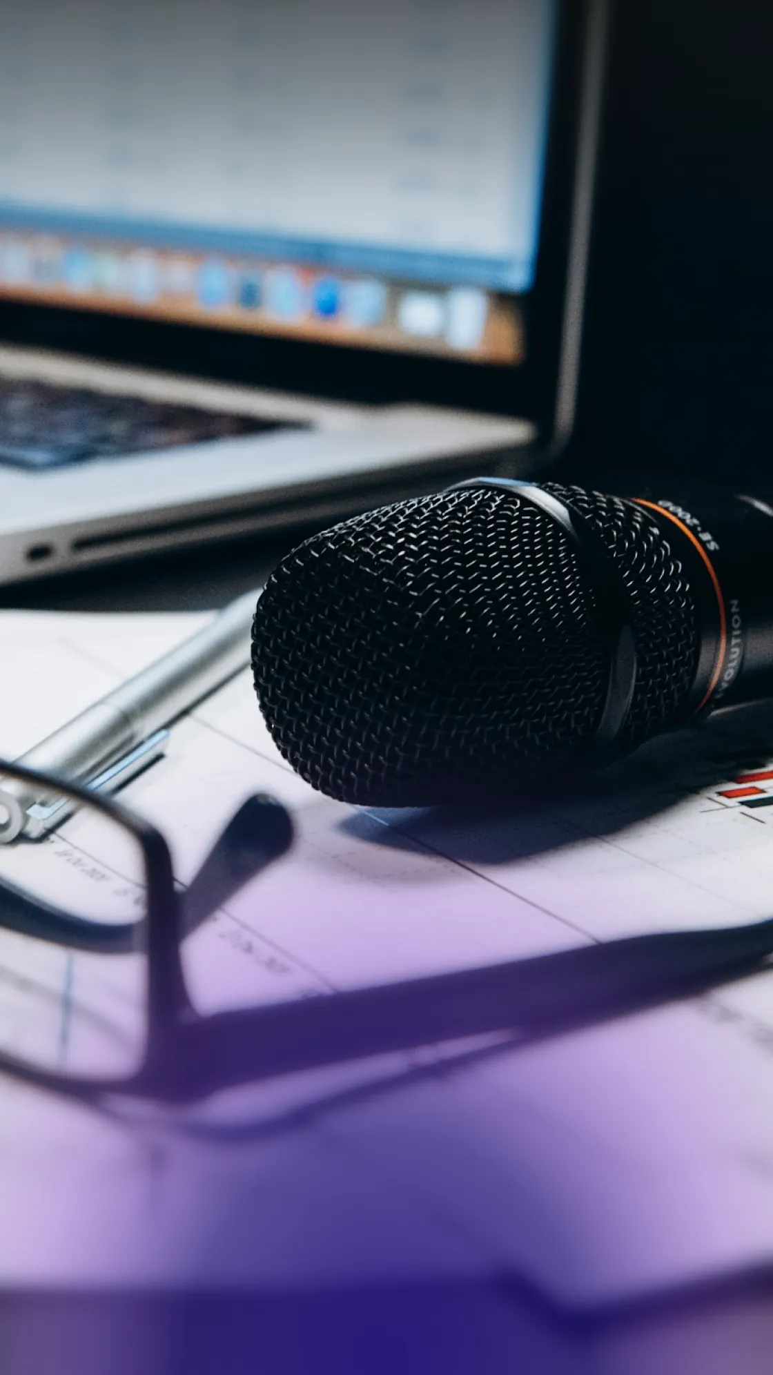Close-up of a karaoke microphone lying on office documents