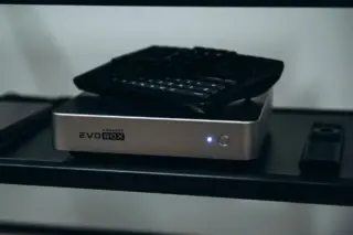 EVOBOX karaoke system with a wireless keyboard and remote on a shelf